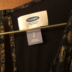 Black and gold patterned sleeveless jumpsuit